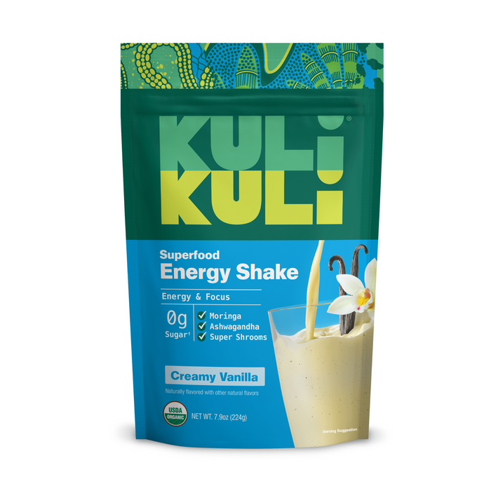 A teal and blue pouch of Kuli Kuli Foods Organic Moringa Green Smoothie + Protein in Creamy Vanilla features a vanilla flower and shake, highlighting zero sugar, moringa greens, ashwagandha, super shrooms, and lasting superfood energy.