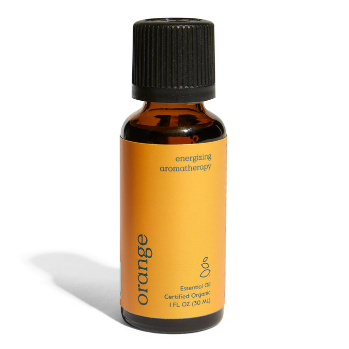 A small amber bottle with a black cap labeled Grove Co. Organic Orange Essential Oil - Energizing Aromatherapy. The vibrant orange label highlights its certified organic status and contains 1 fluid ounce (30 ml).