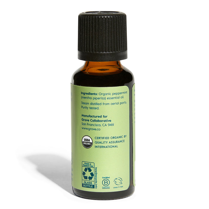 A small amber glass bottle with a black cap from Grove Co. features the label for Organic Peppermint Essential Oil - Relieving Aromatherapy. This USDA-certified organic product showcases ingredients, recycling and certification logos, and manufacturer details, ideal for aromatherapy and home fragrance.