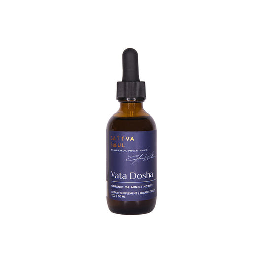 A 2 fl oz brown glass bottle with a dropper lid marked as Sattva Soul Organic Vata Tincture - Calming showcases a dark blue label with white text, stating Ayurvedic herbs and organic calming tincture.