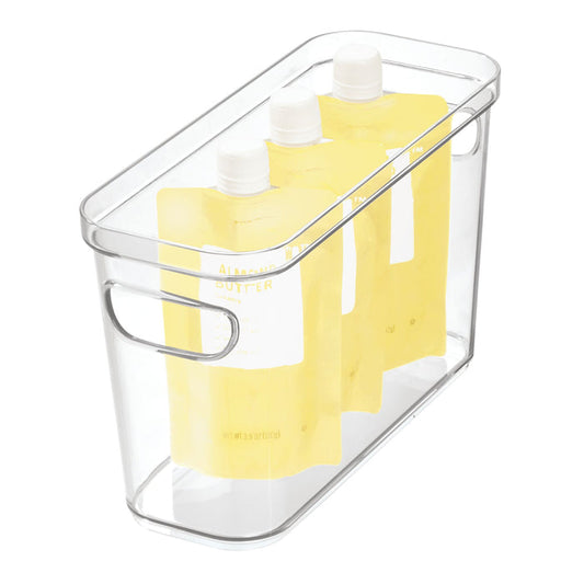 Three yellow spout pouches stand in an iDesign Organizer Bin with Handles made from recycled plastic, showcasing the liquid or gel contents within a clear modular storage solution.