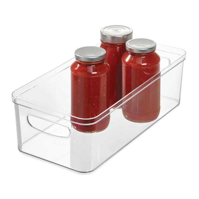 Three jars of tomato sauce with silver lids are neatly arranged inside an iDesign Organizer Bin with Handles, crafted from recycled plastic and featuring side handles for easy transport.