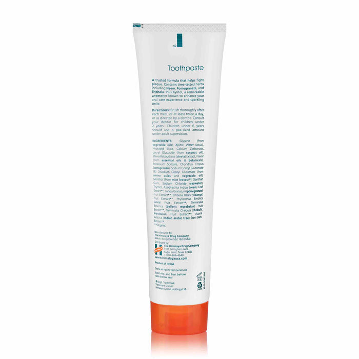 A tube of Himalayas Original Neem & Pomegranate Toothpaste features plant-based benefits and ingredients on the front, with a white body accented by orange and green.