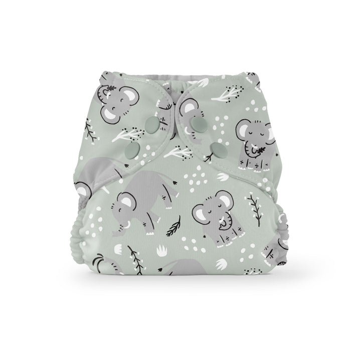 The Esembly Baby Outer Diaper Cover + Swim Diaper in Size 2 is made from 100% OEKO-TEX Certified recycled fabric. It features green cloth with cartoon elephants, leaves, and small white flowers. Snap buttons offer secure fastening, while elastic edges ensure a great fit, with playful gray elephants for charm.