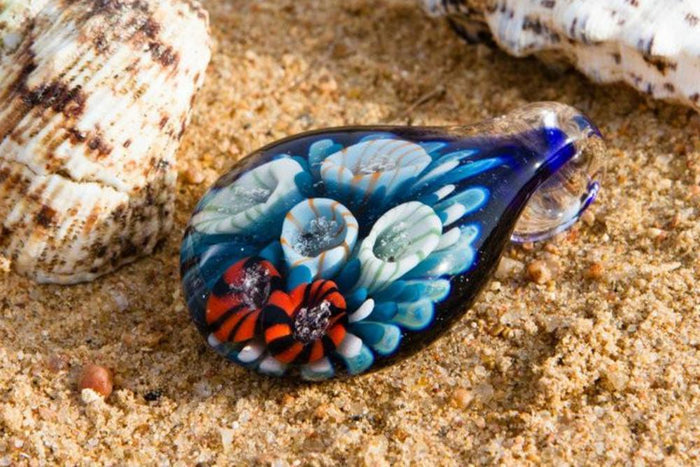 Glass coral reef pendant with blue base and multicolored polyps infused with cremation ashes