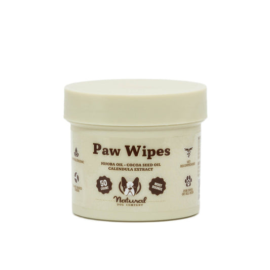 Natural Dog Companys Paw Wipes come in a beige container with 50 wipes enriched with jojoba oil, cocoa seed oil, and calendula extract for natural moisturizing. Perfect for keeping your dogs paws clean and nourished.