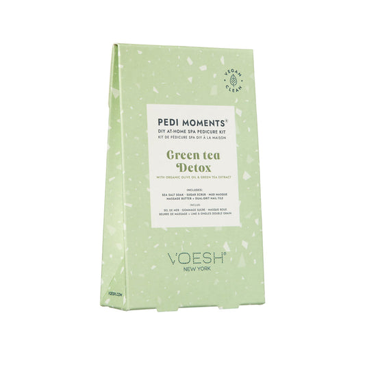 A green rectangular package labeled Pedi Moments from VOESH New York, with green tea detox. Features organic olive and green tea extract for a luxurious at-home spa pedicure. Vegan and clean attributes ensure a true spa experience.