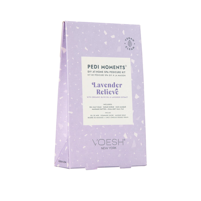 VOESH New Yorks Pedi Moments pedicure kit, in lavender packaging, promises a luxurious spa experience. The front features Lavender Relieve with organic olive and lavender extract, includes a vegan product stamp, and comes with a nail file.