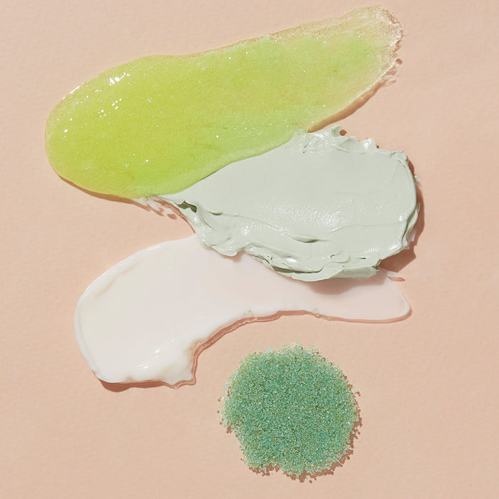 VOESH New Yorks Pedi Moments skincare swatches evoke a spa experience on a light beige background with a translucent green gel, smooth light green cream, thick white cream, and green granules.