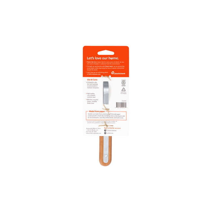 The image shows the packaging for a Full Circle Peeler with an orange and white design. The comfortable handle is partially visible, and the package includes care instructions, details about being dishwasher safe, and sustainability information.
