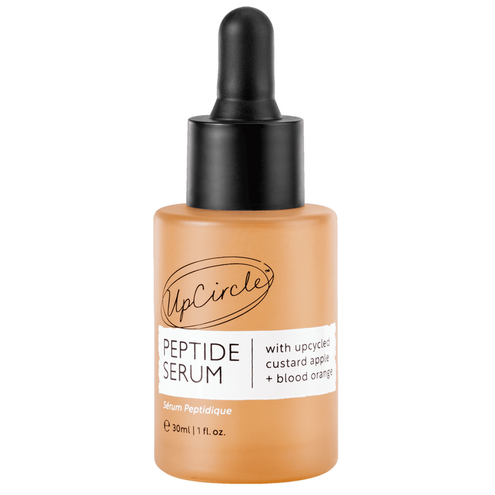 A 30ml bottle of UpCircles Peptide Serum features a black dropper cap. The label promotes upcycled custard apple + blood orange for collagen generation, all set against a plain white background.