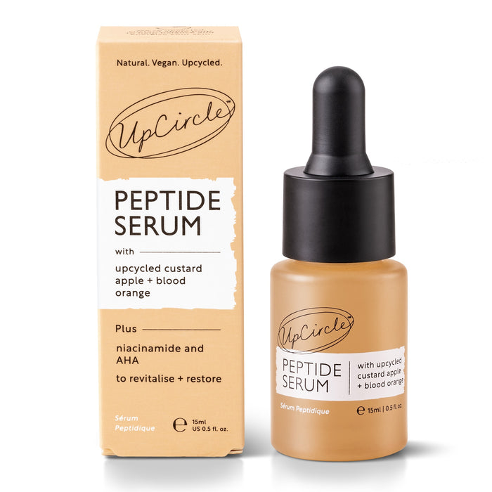 The UpCircle Peptide Serum with Custard Apple + Blood Orange includes upcycled custard apple, blood orange, niacinamide, and AHA to revitalize skin and boost collagen. Its housed in a dropper bottle with packaging that emphasizes its natural, vegan ingredients and sustainability.