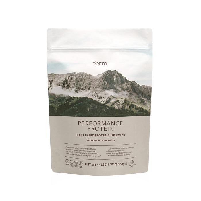 Form Nutrition Performance Protein in a resealable pouch, chocolate hazelnut flavor, showcases a mountain design and offers 30g plant-based protein for post-workout recovery with low carbs. The net weight is 18.3 oz (520g).