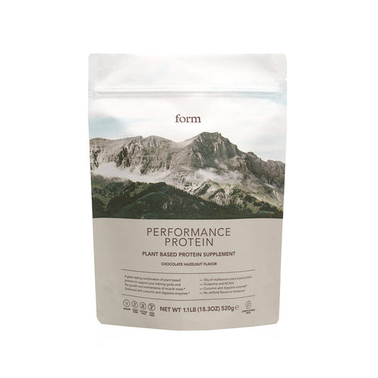 Form Nutrition Performance Protein in a resealable pouch, chocolate hazelnut flavor, showcases a mountain design and offers 30g plant-based protein for post-workout recovery with low carbs. The net weight is 18.3 oz (520g).