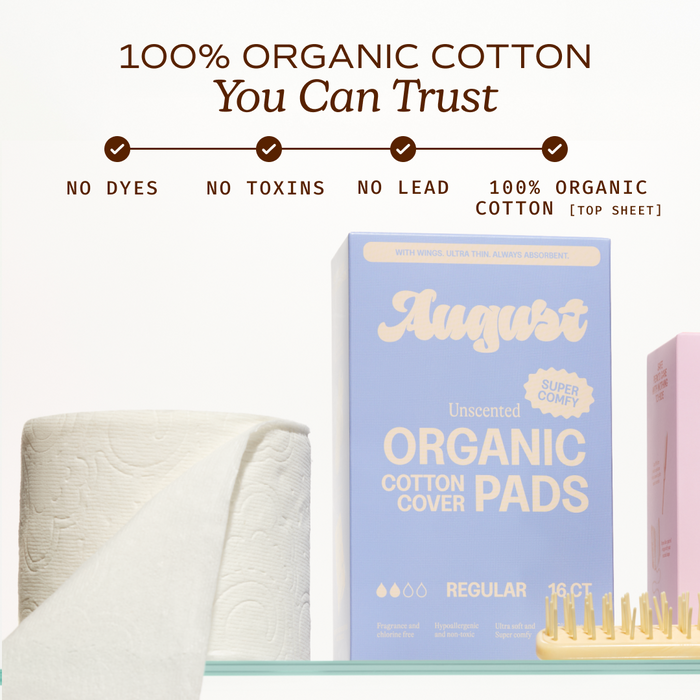 An August Night Pad box sits next to a toilet paper roll and wooden brush. Above, text reads “100% organic cotton you can trust”—with no dyes, toxins, or lead.