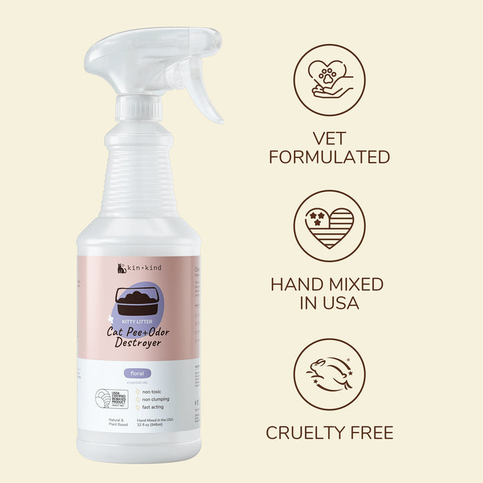A transparent spray bottle labeled Pet Pee + Stain + Odor Remover Spray for Kitty Litter from kin+kind, featuring a floral scent and powerful odor elimination. Iconic labels read: Vet Formulated, Hand Mixed in USA, and Cruelty Free, showcasing its non-toxic formula with corresponding symbols.