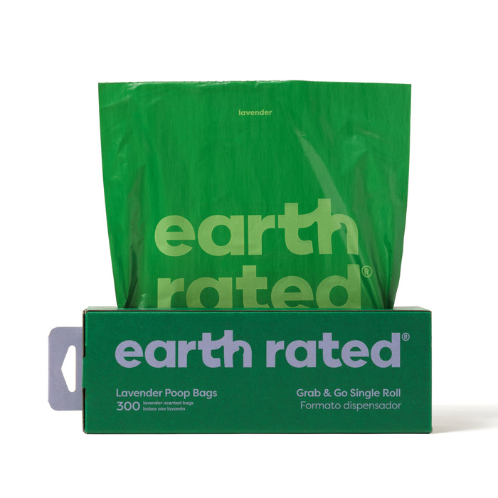 A green box of Earth Rateds Large Single Roll Refill pet waste bags, made from recycled plastic with a lavender scent, is partially open revealing one bag. It states 300 Leak-Proof Lavender Poop Bags and Grab & Go Single Roll in both English and Spanish.