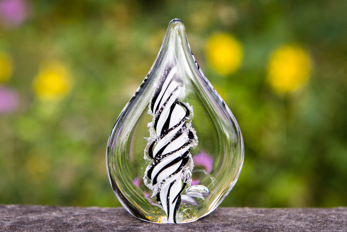 Petite memorial glass flame infused with cremation ashes, black and white spiral design inside clear glass.
