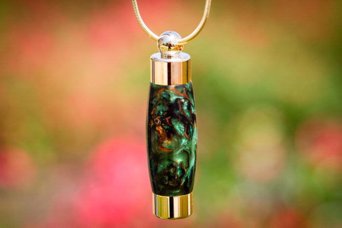 Green marbled acrylic cremains keepsake pendant on a gold chain with gold end caps