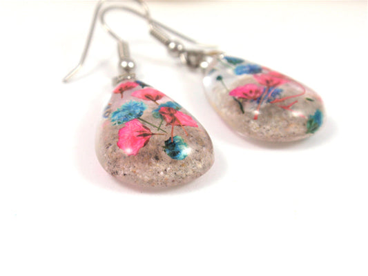 Teardrop crystal resin earrings with pink and blue baby's breath preserved in cremains on surgical steel hooks
