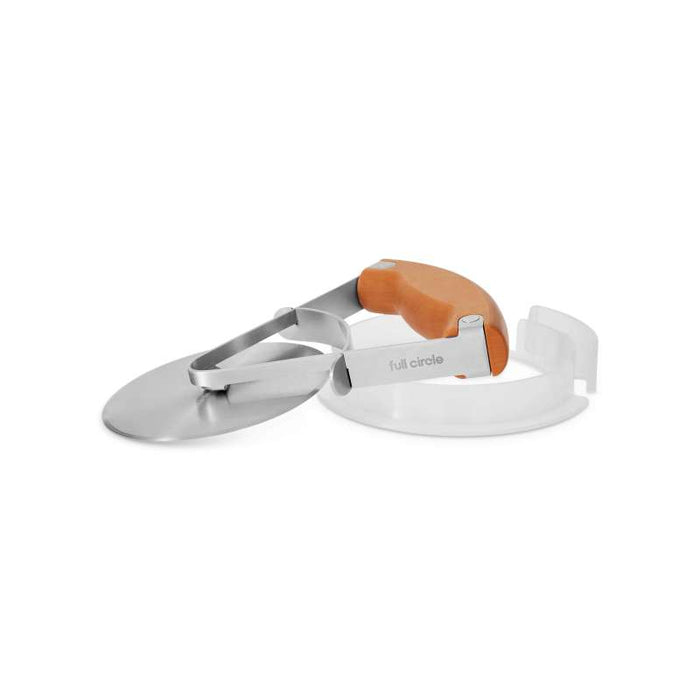 The Full Circle Pizza Wheel, with a silver circular blade and an orange hover-style handle, offers a strong grip and sleek design. It includes a white, semi-circular recycled plastic safety cover for precision cutting and sustainability.