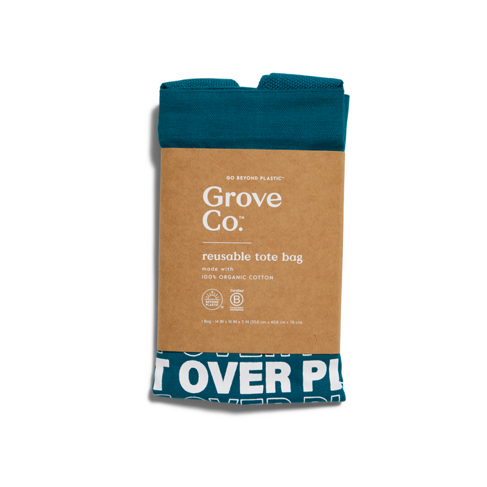 The Planet Over Plastic Reusable Tote Bag by Grove Co. is folded with a brown paper label, boasting its made from 100% organic cotton. Embrace a plastic-free lifestyle with this bag showcasing white text on a teal bottom.