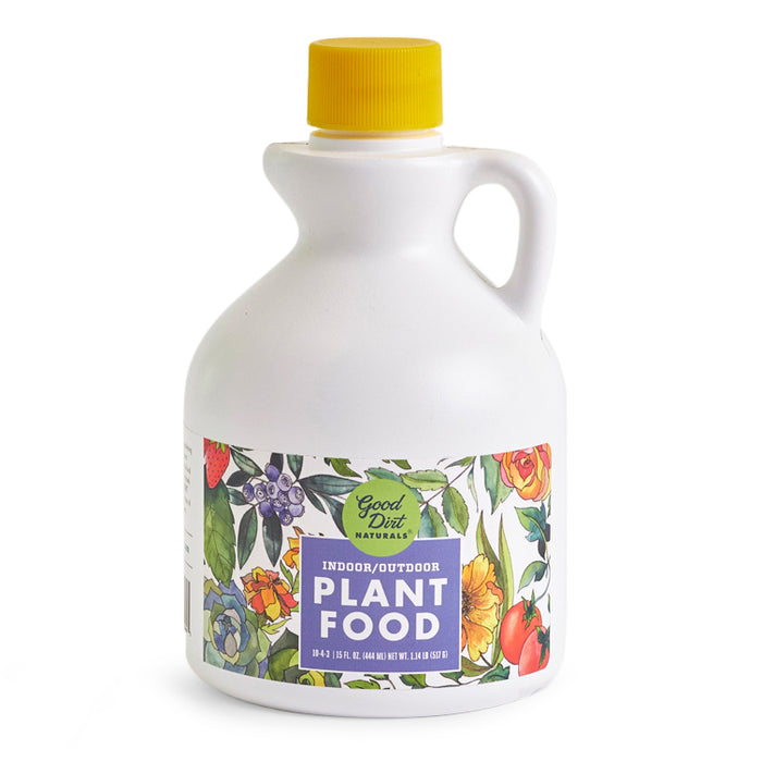 White bottle with yellow cap featuring floral design and the text Good Dirt Plant Food. Ideal for indoor/outdoor use, this sustainable, chemical-free plant food includes a convenient side handle for easy use.