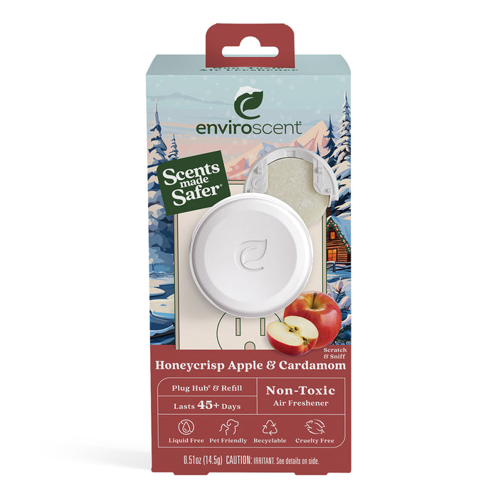 Enviroscents Plug-in Air Freshener Starter Set includes a liquid-free plug-in hub and refill, lasting over 45 days. Its non-toxic, cruelty-free, and features an illustrated snowy landscape with apples and spices.