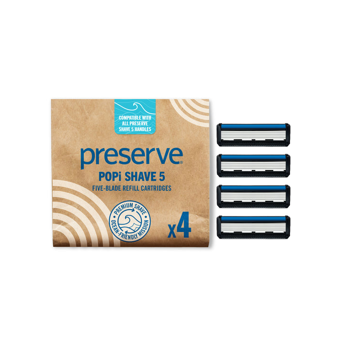 A pack of Preserve Shave 5 Replacement Blades—eco-friendly razor cartridges designed for the Shave 5 and POPi Shave 5 handles—containing four cartridges displayed beside a brown and blue box marked with compatibility for all Preserve shave handles.