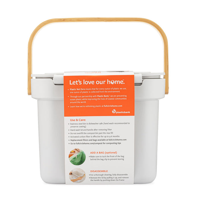 The Full Circle Post Modern Compost Bin is a white kitchen compost collector with a wooden handle and includes an activated carbon filter to reduce odors. It features a Lets love our home label and an orange section highlighting its benefits, adding style to your kitchen.