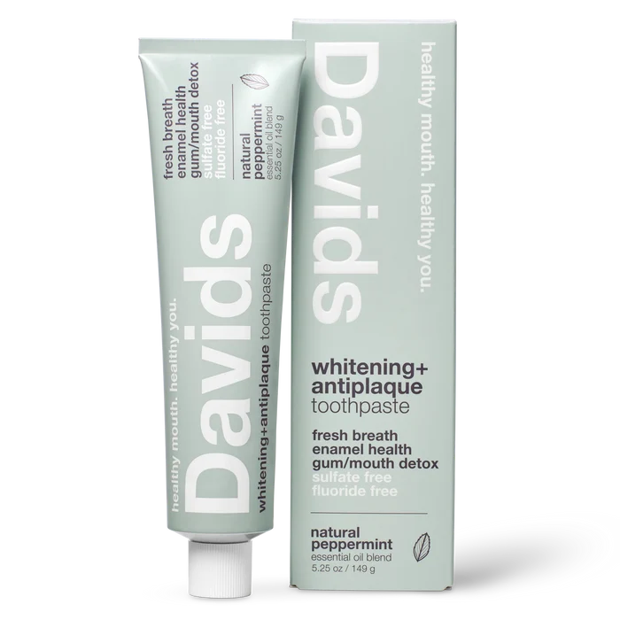 A tube and box of Davids Premium Toothpaste - Whitening + Antiplaque in natural peppermint flavor, designed with a minimalist light green look and white text showcasing features such as fluoride-free formula, support for enamel health, and EWG Verified natural whitening.