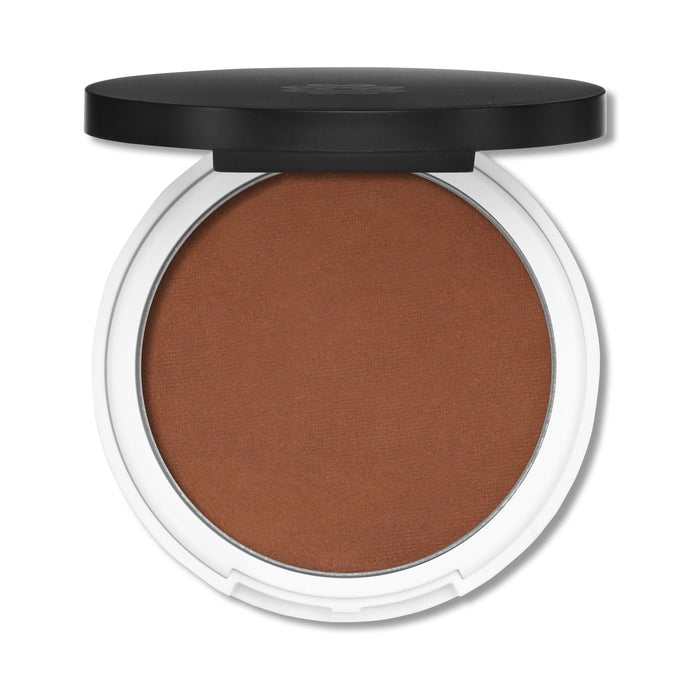 Lily Lolos Pressed Bronzer, housed in a round white compact with a sleek black lid, boasts a rich brown shade made from natural minerals for smooth, even application. The partially open lid unveils the secret to your sun-kissed glow.