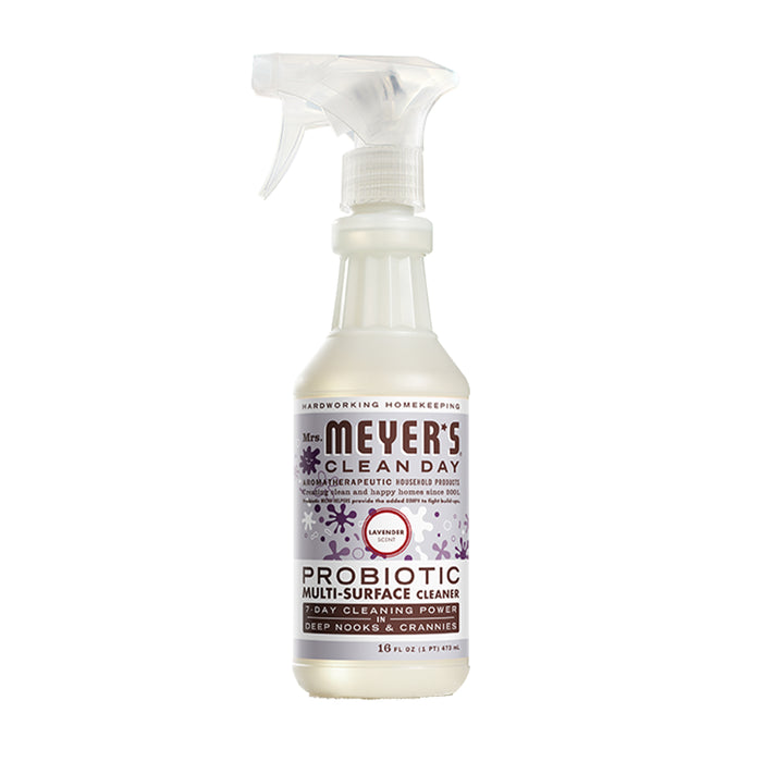 A spray bottle of Mrs. Meyers Probiotic Multi-Surface Cleaning Spray features a lavender scent, purple graphics, and text on the label, with a transparent bottle and white trigger nozzle.