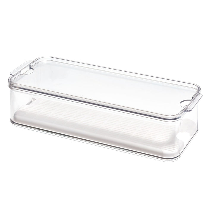 The iDesign Produce Fridge Bin, crafted from recycled BPA-free plastic, is a transparent rectangular container with a clear lid featuring integrated handles for easy lifting and includes a white draining tray to efficiently store produce.