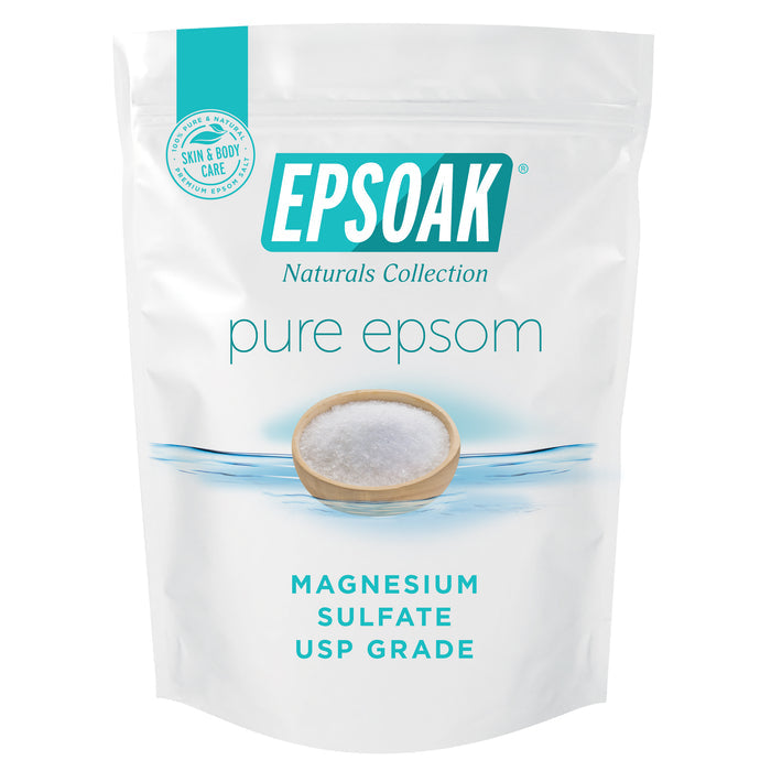 A white San Francisco Salt Co bag labeled “Pure Epsom Salts - USP Grade” features a bowl of crystals and a Skin & Body Care seal, highlighting its relaxing soak and muscle pain relief benefits.