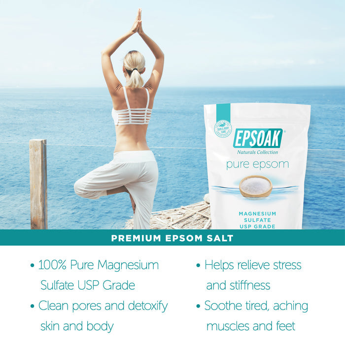 A woman practices yoga on a seaside deck with arms raised. In the foreground, San Francisco Salt Co Pure Epsom Salts - USP Grade sits, promoting muscle pain relief on a teal banner—ideal for a soothing soak after yoga.