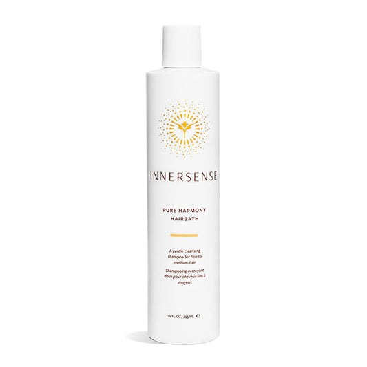 Innersense Organic Beautys Pure Harmony Hairbath comes in a white cylindrical bottle with a yellow geometric label. This gentle, sulfate-free shampoo is designed for fine to medium hair and contains an organic blend. The bottle holds 10 fl oz (295 mL).