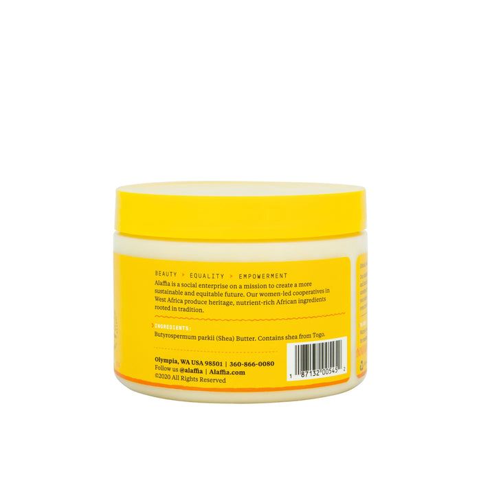 A yellow jar of Alaffias Pure Unrefined Shea Butter for dry skin shows its back label with Beauty, Equality, Empowerment, contact info, and a barcode. The moisturizer features a yellow lid atop a mostly white container.
