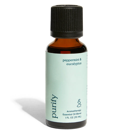 A 1 fl oz (30 mL) amber bottle with a black cap labeled Purify Essential Oil Blend - Peppermint & Eucalyptus by Grove Co. features a light green label and offers a refreshing aromatherapy home fragrance.