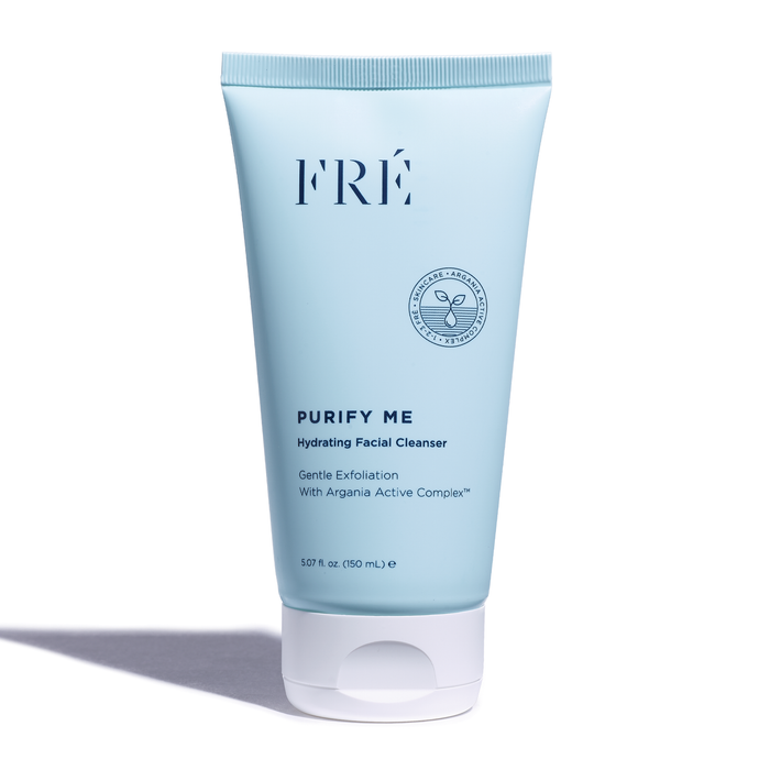 A light blue tube of FRÉ Skincares PURIFY ME Hydrating Facial Cleanser with a white cap features the Argania Active Complex™. It gently exfoliates and minimizes pores, delivering 150 mL (5.07 fl oz) of skincare benefits, casting a subtle shadow in front.