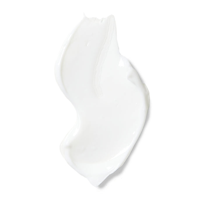 A smear of Rooted Beautys Purifying Overnight Recovery Cream with a smooth, shiny texture forms an elongated wave on a white background. Enriched with R7 Complex and hyaluronic acid, it offers deep hydration.