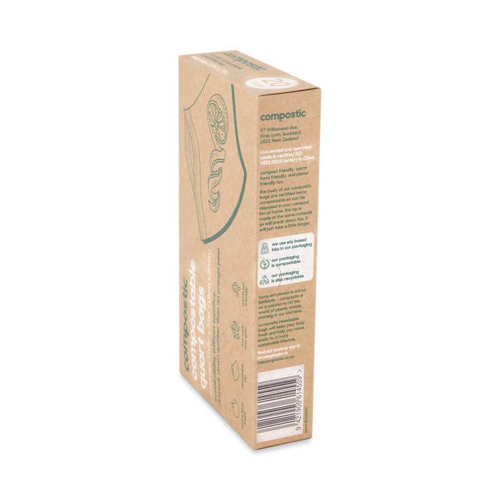 A cardboard box of Compostic Quart Bags showcases eco-friendly icons and text emphasizing its plant-based materials. The mostly brown packaging with green accents prominently features a biodegradable symbol, highlighting its sustainable benefits.