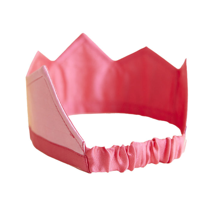 The Rainbow Crown by Sarahs Silks is a pink silk crown with an elastic back band and pointed arches on top. Its soft material and simple, playful design make it perfect for imaginative dress-up play.