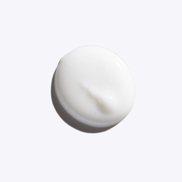 A dollop of RECOVER ME Restorative Night Cream by FRÉ Skincare, featuring a smooth texture and niacinamide, displayed on a plain light gray background.