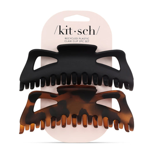 The Recycled Plastic Jumbo Claw Clip Set by Kitsch features two jumbo clips on a card: one solid black and one tortoiseshell. The stylish, eco-friendly set highlights sustainable materials and chic packaging.
