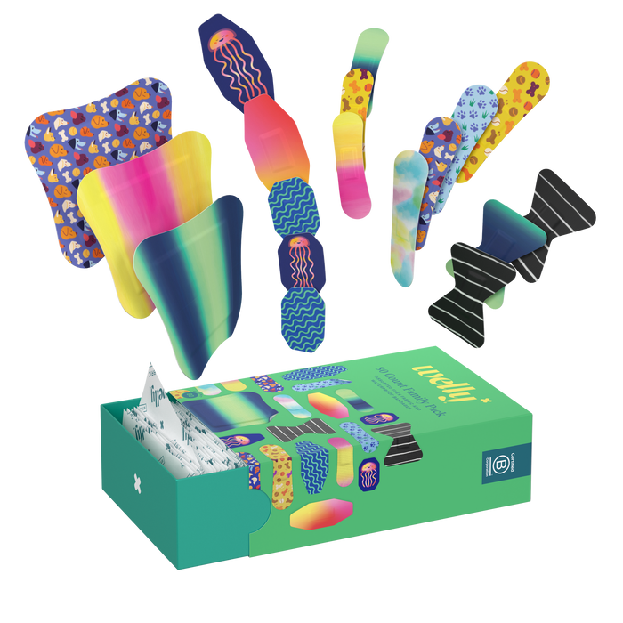 A green Welly Refill Box with assorted adhesive bandages, including flex fabric and waterproof types, is open with bandages spilling out. Designs have gradients, stripes, and animal prints. Individual bandages and smaller boxes for portable first-aid kits are also visible.