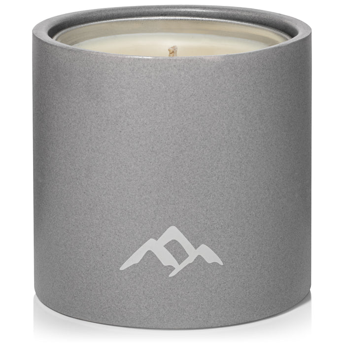 The Refillable Mosquito Repellent Candle by Murphys Naturals is a cylindrical gray candle infused with essential oils. It features a minimalist mountain logo and an untouched wick, housed in a smooth container, making it a stylish and aromatic addition to any space.