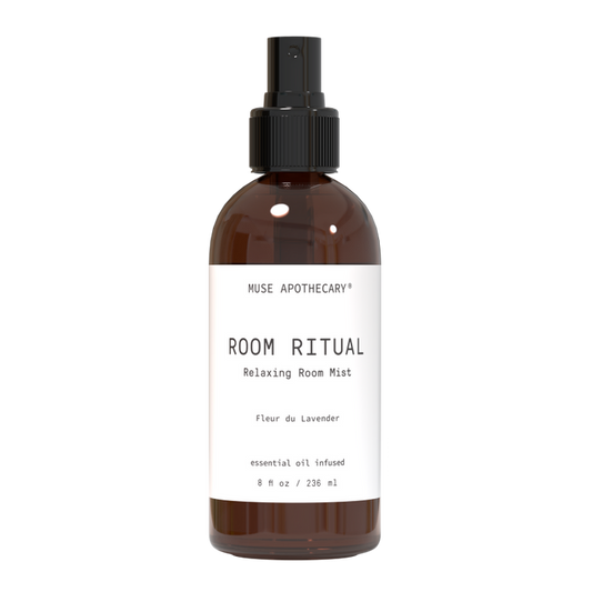 A brown bottle with a black spray nozzle, labeled Muse Apothecary Relaxing Room Mist, contains an aromatherapeutic blend of Fleur du Lavender. This 8 fl oz natural essential oil product is designed to soothe and calm your space.