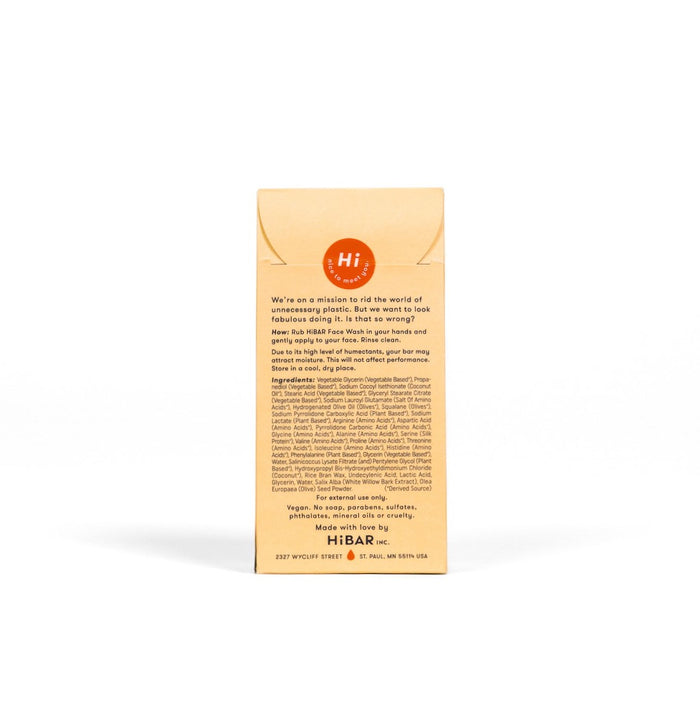Back of a HiBAR Renew Solid Face Wash beige box showcases the brand’s eco-friendly mission and sustainable ingredients, featuring olive seed powder for gentle exfoliation. Address: 2257 Wycliff Street #2, St. Paul, MN 55114 USA.