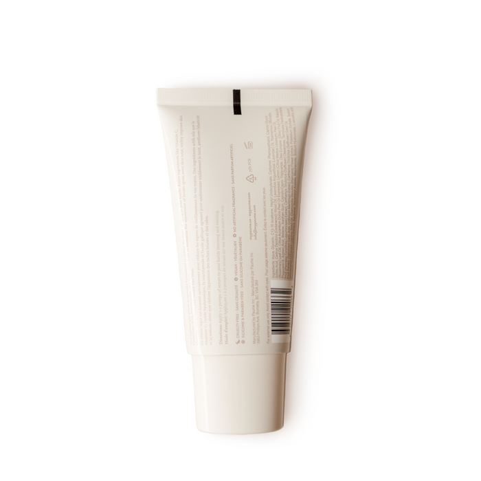 A white tube with a black stripe near the top displays Renewing Hand Serum by PAUME, with printed text and a barcode highlighting its anti-aging formula. The tube stands on a white background.